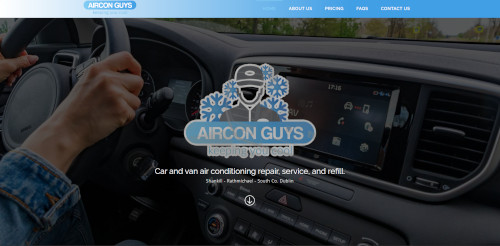 Interior view of a vehicle showing a person holding the steering wheel, with a modern dashboard display featuring air conditioning controls. The logo for 'Aircon Guys' is prominently displayed with a snowflake design.