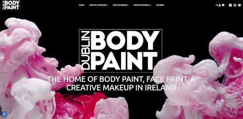 A website homepage featuring colorful swirls of pink and white paint against a black background. The text in the center states 'Dublin Body Paint' along with a tagline about body paint, face paint, and creative makeup in Ireland.