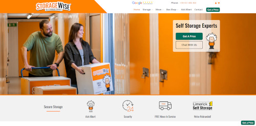 A man and woman moving storage boxes in a facility with orange doors. The woman points towards the camera while the man looks at her. The StorageWise logo is visible in the foreground, along with navigation links for storage services.